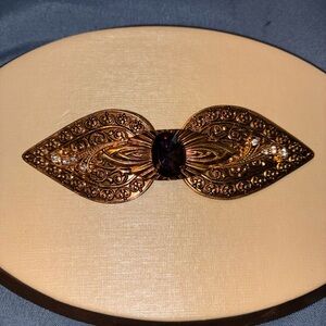 Ornate Gold Brooch with Gemstone Accent